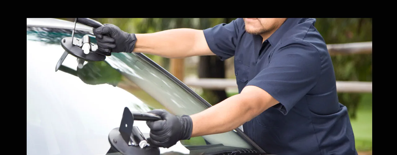 Mobile auto glass technician working on a vehicle